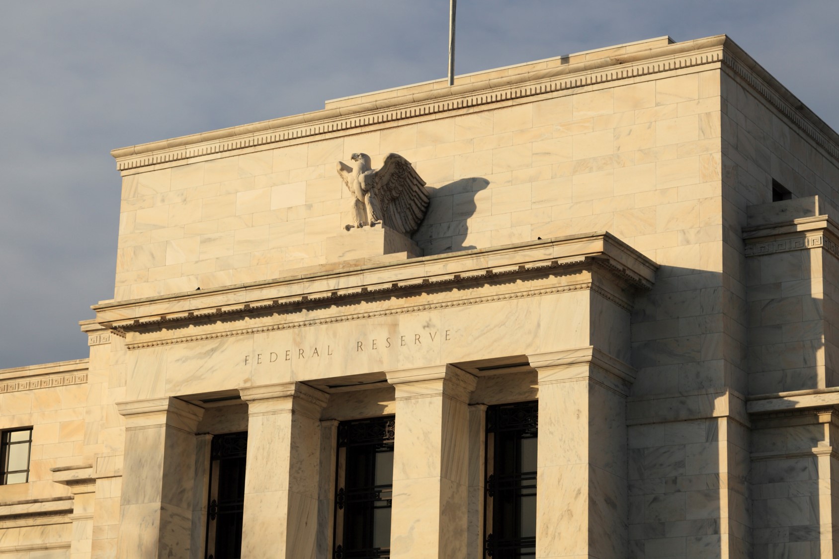 Fed trims growth forecasts